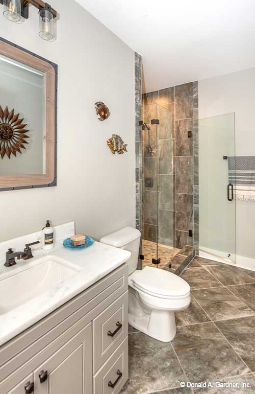 Single sink vanity and glass walk-in shower in the bathroom. The Hunter Creek plan 1326.