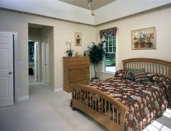 This is a photograph of the master bedroom of three bedroom house plan 831 The Idlewild as built by a customer