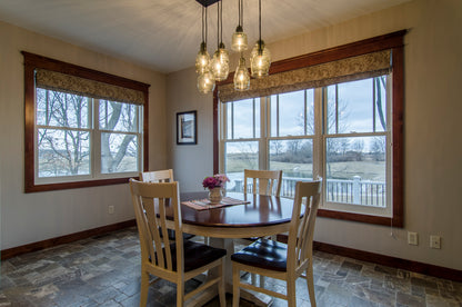 Five windows and pendant lighting in the dining room. The Irby plan 993.