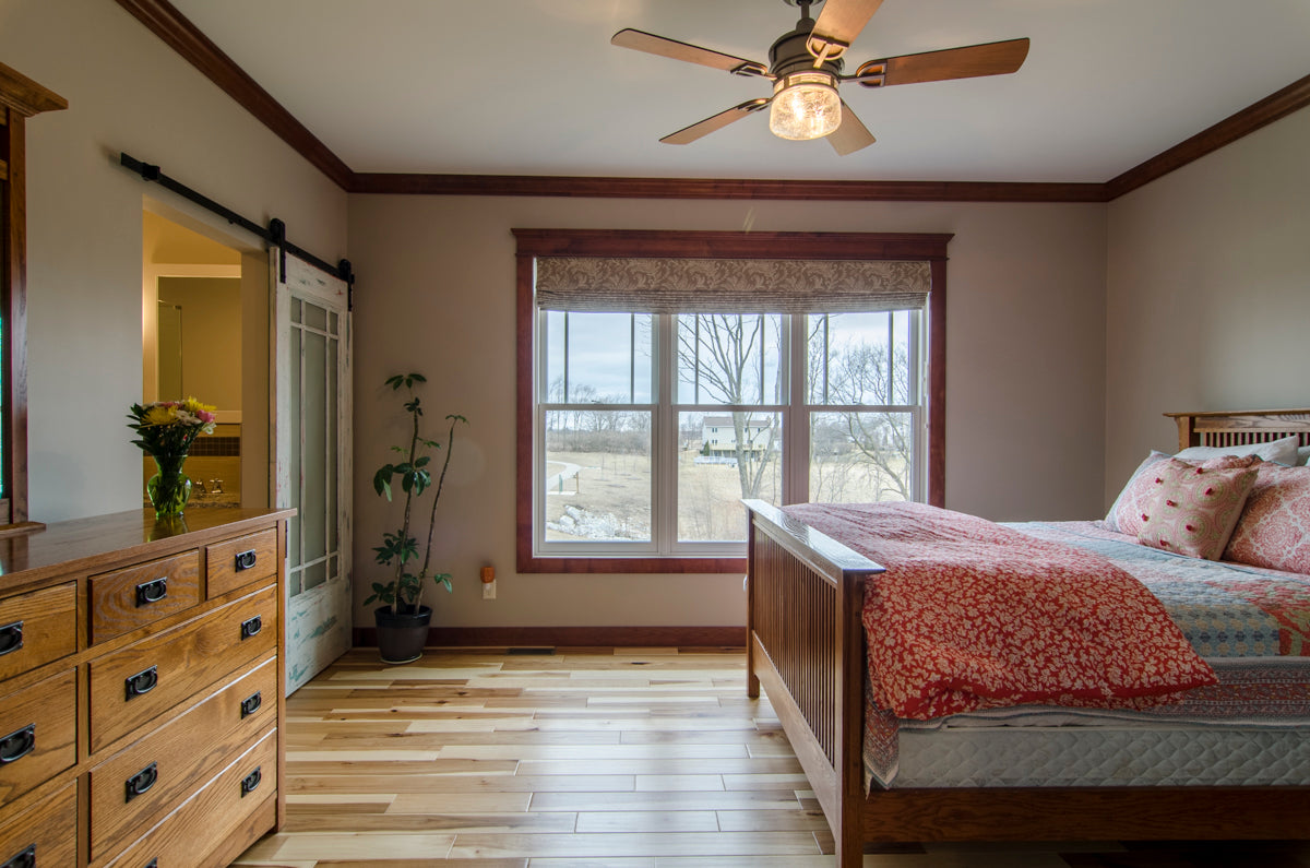 Stained wood crown molding along the ceiling and windows in the master bedroom. The Irby plan 993.