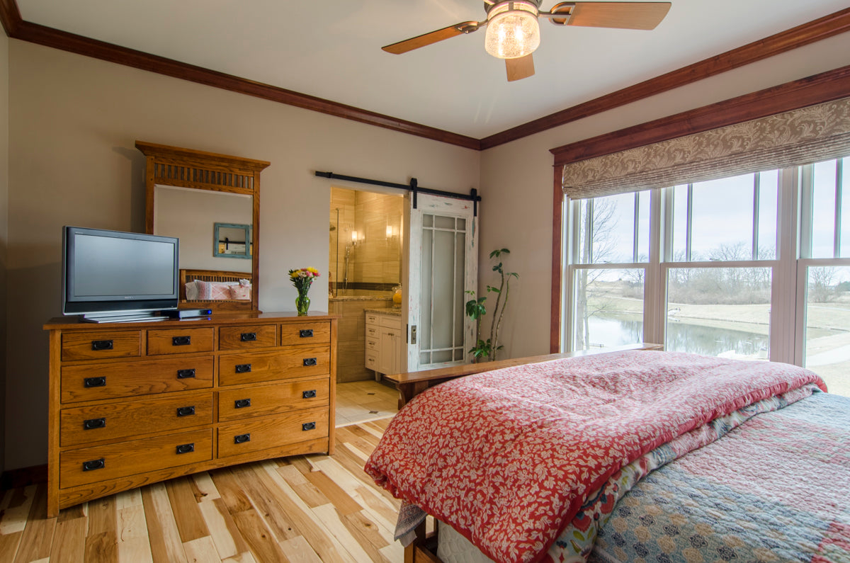 Farmhouse style sliding door in the master bedroom. The Irby plan 993.