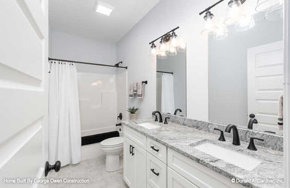 Double sink vanity and shower bath combo in the bathroom. The Ireland plan 346.