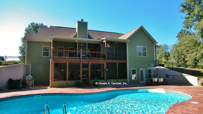 This is a photograph of the rear of farmhouse house plan 1075 The Ives as built by a customer