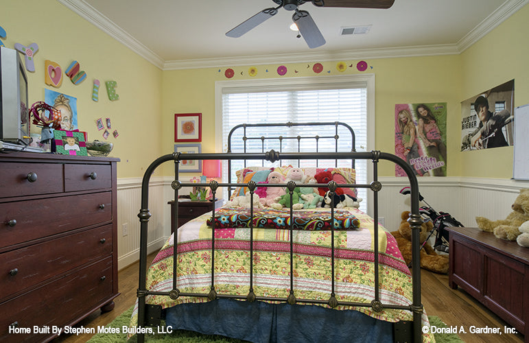 Secondary bedroom with crown molding along ceiling and chair railing above beadboard on lower walls. The Ivy Creek plan 921