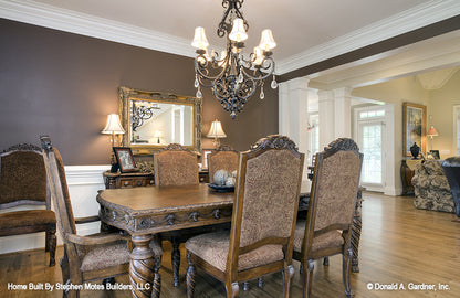 Elegant dining room with crown molding and chair rail. The Ivy Creek plan 921