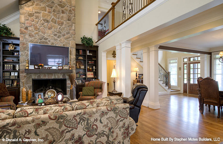 Great room view of the fireplace with stone work and banister above. The Ivy Creek plan 921