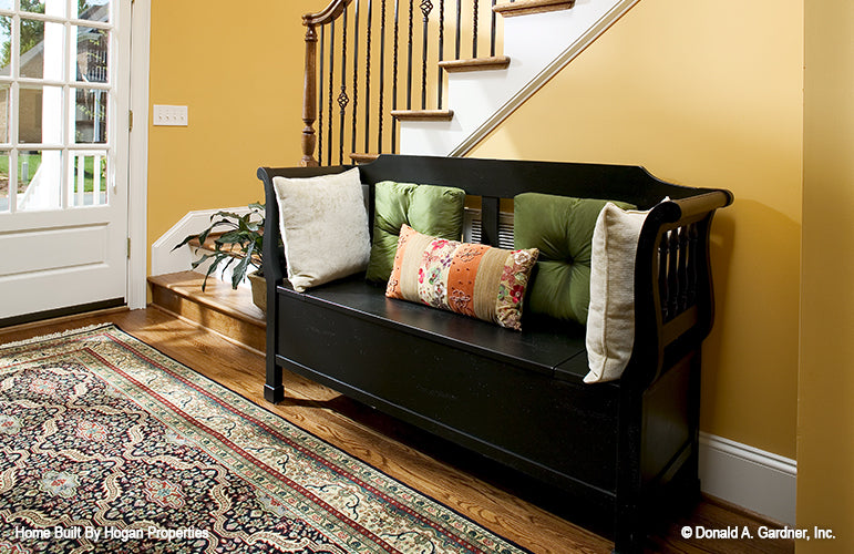 Bench seating next to the staircase in the foyer. The Jamestowne plan 828. 