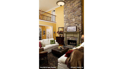 Second story great room with floor to ceiling stone fireplace. The Jamestowne plan 828. 