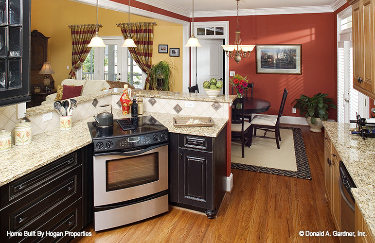 Black cabinets and granite countertops in the kitchen. The Jamestowne plan 828. 