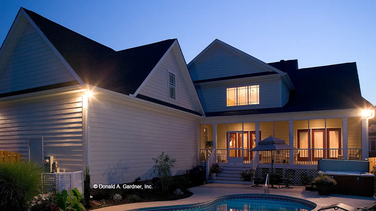 Rear view photograph with a screened in porch. The Jamestowne plan 828. 