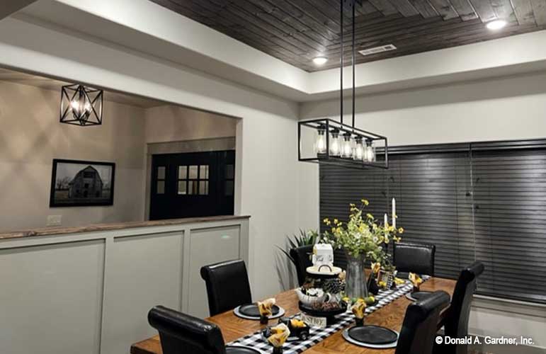 Dining room with tray ceiling and wood accent on the ceiling. Janet plan 1513