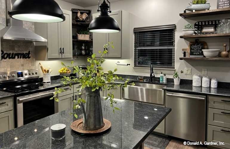 Kitchen with dark granite counter tops and open shelves. Janet plan 1513