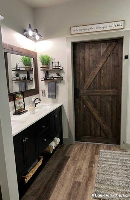 Double sink vanity in master bathroom, farmhouse style door and mirror trim. Janet plan 1513