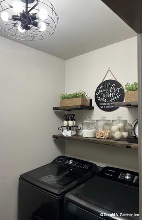 Farm house style laundry area in the utility room, open shelf storage. Janet plan 1513