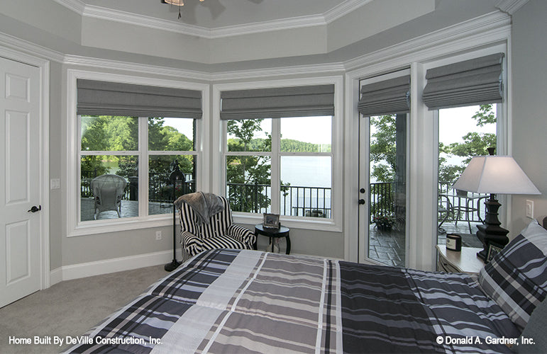 Secondary bedroom with lakeview windows and exterior door to the patio. The Jasper Hill plan 5020.