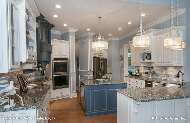 Island in the center of the kitchen with a sink. The Jasper Hill plan 5020.