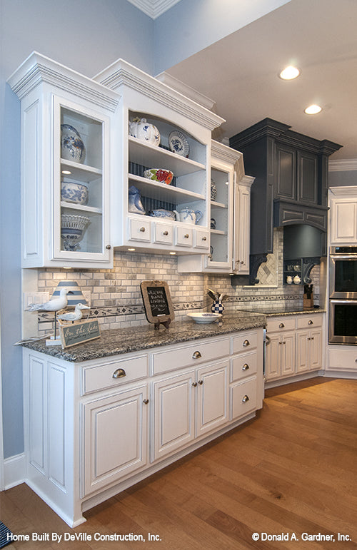 Cabinets with glass doors in the kitchen. The Jasper Hill plan 5020.