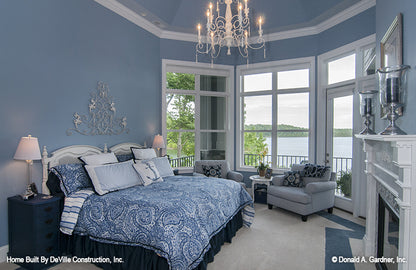 Fireplace and patio door in the master bedroom. The Jasper Hill plan 5020.