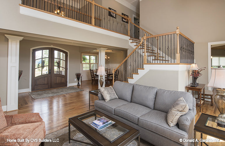 Great room picture with upstairs railing of luxury house plan 1033 The Jerivale