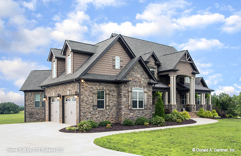 Picture of front and garage side of luxury house plan 1033 The Jerivale