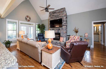 Vaulted ceiling and stone fireplace in the great room. The Landry plan 1291.