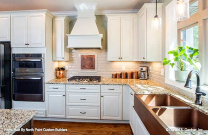 Double copper sink in the kitchen and white cabinets. The Landry plan 1291.