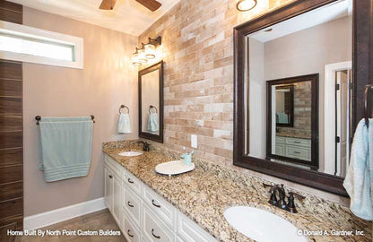 Double sink vanity and separate mirrors in the master bathroom. The Landry plan 1291.