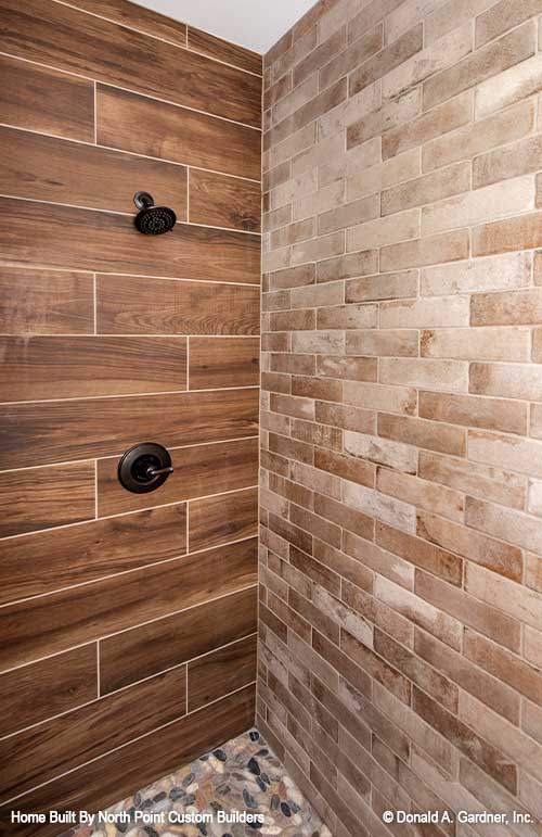 Two types of tiles in the shower with pebble flooring in the master walk-in shower. The Landry plan 1291.