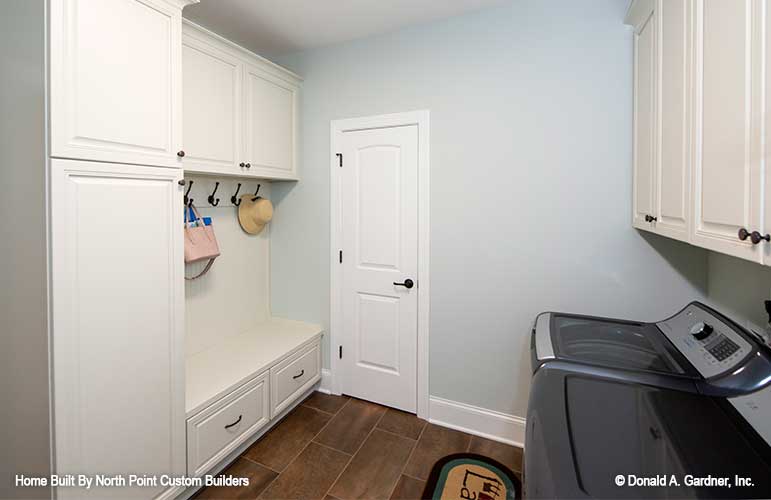 Bench and hooks for storage in the utility room. The Landry plan 1291.