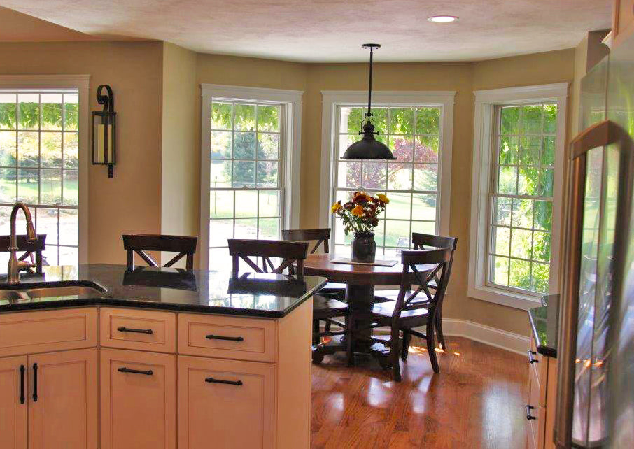 Breakfast nook with three surrounding windows and a hanging light. The Larson plan 1629.