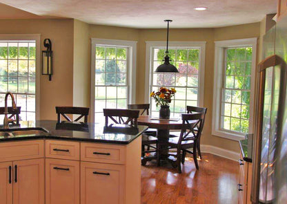 Breakfast nook with three surrounding windows and a hanging light. The Larson plan 1629.