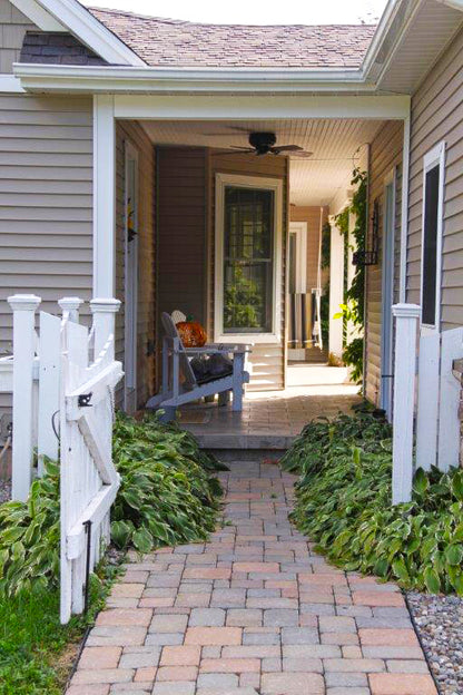 Stone walkway to the breezeway. The Larson plan 1629.