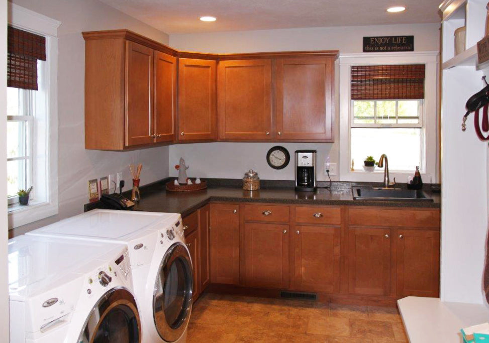 Brown cabinets in the utility room. The Larson plan 1629.