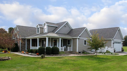 A side view photograph with the garage. The Larson plan 1629.