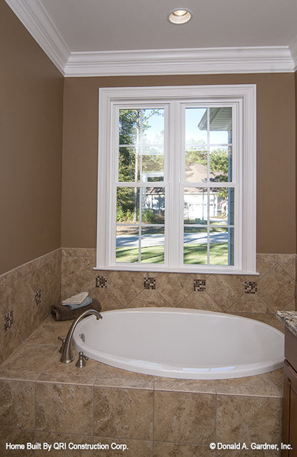 Master bathroom sitting tub with windows above. The Lennon plan 1300