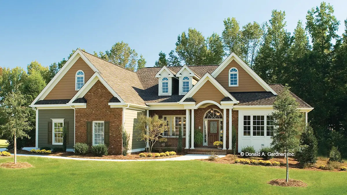 Twin dormers, multiple gables and bold columns create a lovely Traditional exterior for this four-bedroom home