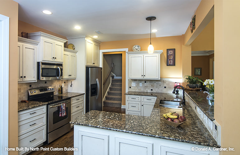 Flat ceiling with recessed lights in the kitchen. The Lisenby plan #1220.