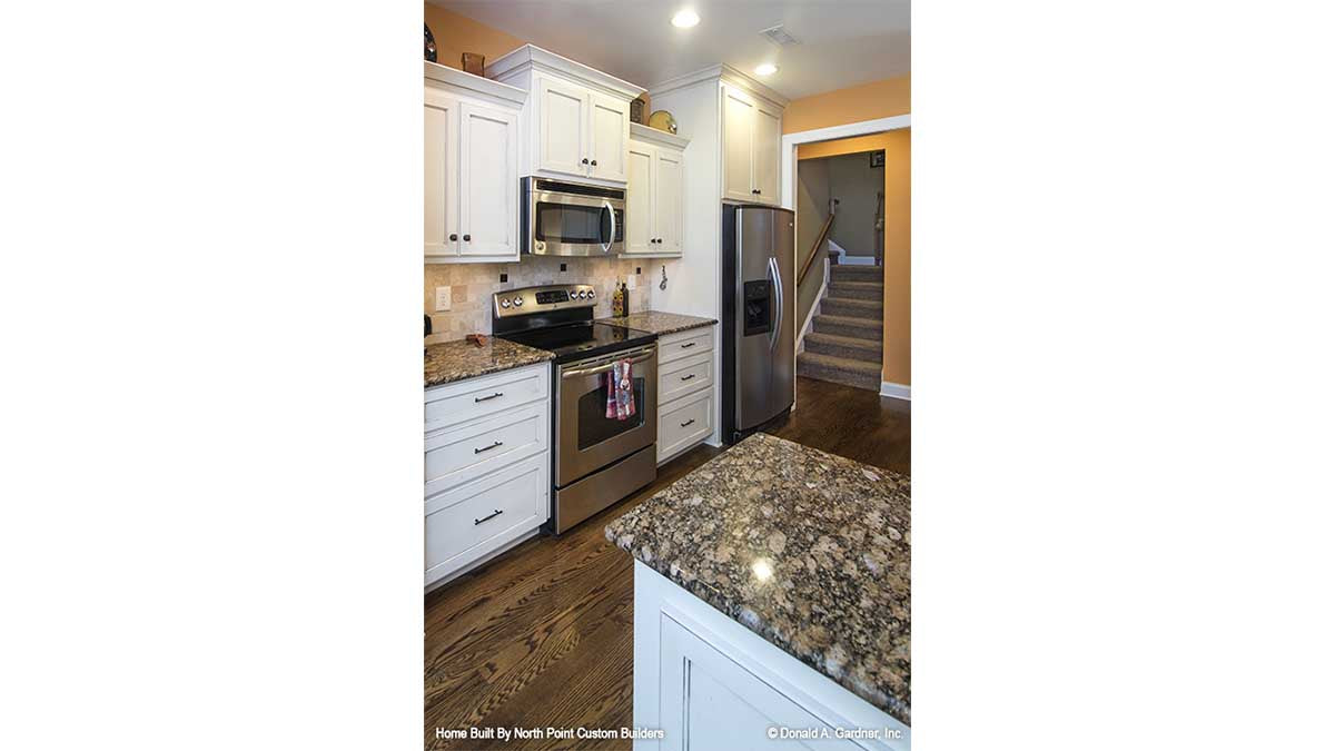 Stainless-steel appliances in the kitchen. The Lisenby plan #1220.