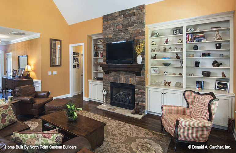 Floor to ceiling stone fireplace in the living room. The Lisenby plan #1220.