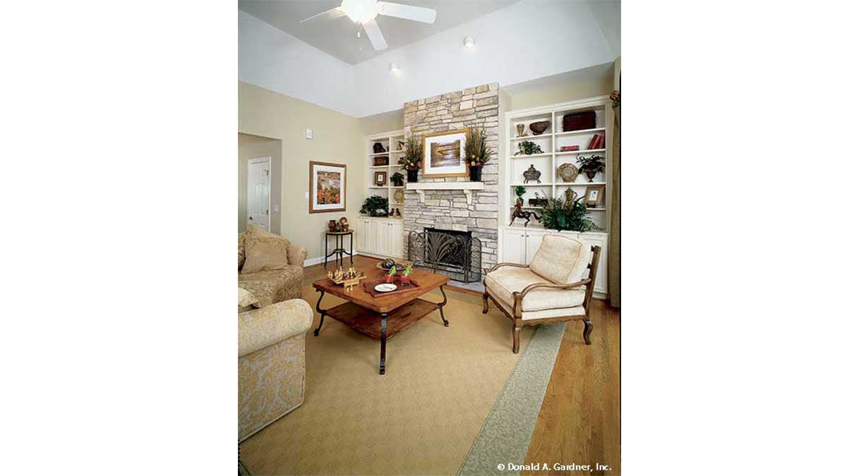 Tray ceiling and floor to ceiling stone fireplace in the great room. The Longleaf plan 802.