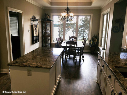 Dining room with rear view pictured for house plan 1319 The Lucerne