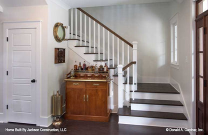 Bar cart nestled between the staircase and the coat closet.  Lucinda plan 1514