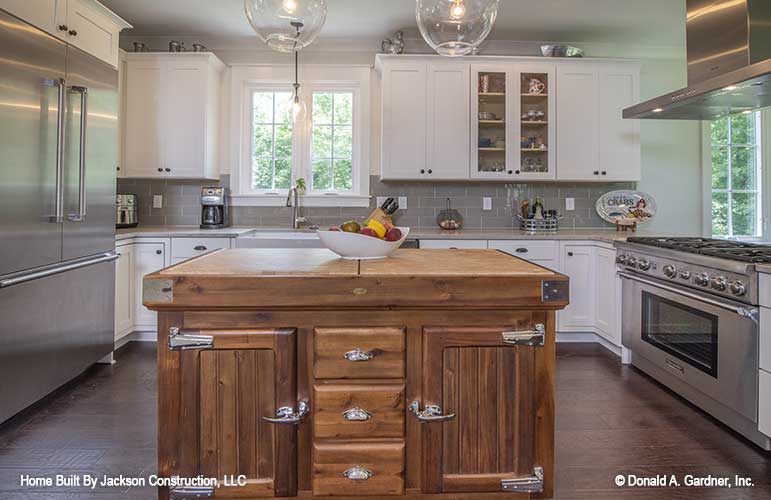 Butcher block kitchen island and stainless steel appliances.  Lucinda plan 1514