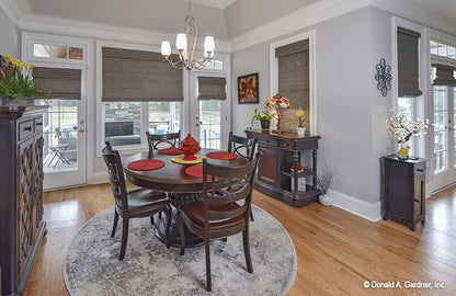 Inviting dining room with natural light from the large window and two patio doors. The Lucy plan 1415