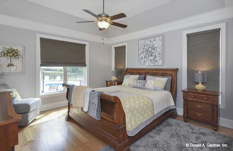 Cozy master room with tray ceilings and large window with view to the backyard. The Lucy plan 1415