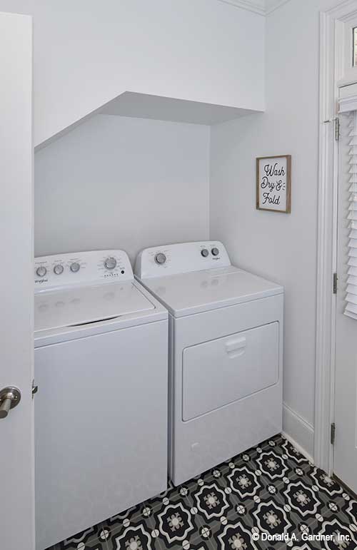 Washer and dryer nestled into the wall beneath the stairs. The Lucy plan 1415