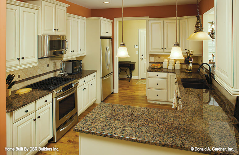 White cabinets in kitchen. The Lujack plan 1043.