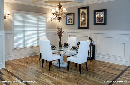 Chandelier and large windows in the dining room. The MacAllaster plan 838. 