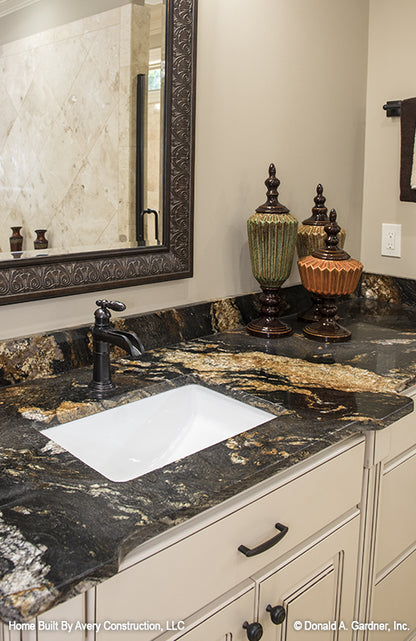 Dark counter tops and white cabinets in the master bathroom. The MacAllaster plan 838. 