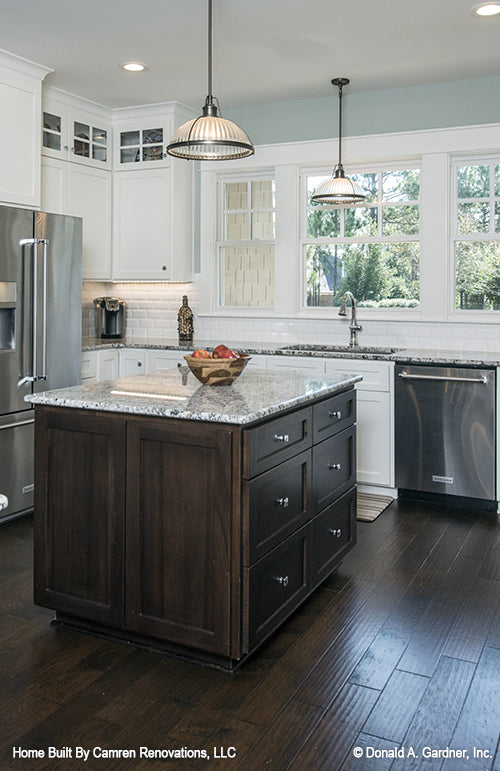 Kitchen island and workspace with sink and windows for Markham house plan 1299